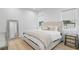 Bright bedroom featuring a bed with tufted headboard, bedside table, and a mirror at 503 W Davis Blvd, Tampa, FL 33606