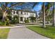 Elegant two-story home showcasing manicured landscaping, a paver driveway, and a modern architectural design at 503 W Davis Blvd, Tampa, FL 33606