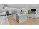 Bright kitchen featuring stainless steel appliances, a center island, and an open layout to the living area at 503 W Davis Blvd, Tampa, FL 33606