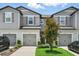Charming townhome with gray siding, well-maintained landscaping, and a single-car garage at 5110 Sylvester Loop, Tampa, FL 33610