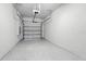 A clean and spacious two car garage featuring speckled flooring and an automatic door at 5110 Sylvester Loop, Tampa, FL 33610