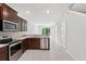 This contemporary kitchen features dark wood cabinetry, stainless steel appliances, and tile flooring at 5110 Sylvester Loop, Tampa, FL 33610