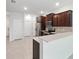 A modern kitchen featuring stainless steel appliances, quartz countertops, and tile flooring at 5110 Sylvester Loop, Tampa, FL 33610