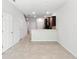 Spacious open floor plan with neutral walls and tile flooring leading to the kitchen at 5110 Sylvester Loop, Tampa, FL 33610