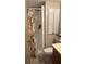 Small bathroom includes vanity, shower, and cabinet at 5541 Bay Blvd # 303, Port Richey, FL 34668