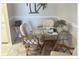 Cozy dining area with a glass table and decorative rattan chairs at 5541 Bay Blvd # 303, Port Richey, FL 34668