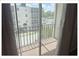 Balcony overlooking condo exterior and parking with tree-lined perimeter at 5541 Bay Blvd # 310, Port Richey, FL 34668