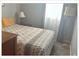 Cozy bedroom with large window, and decorative lamp at 5541 Bay Blvd # 310, Port Richey, FL 34668