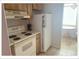 Efficient kitchen space with white appliances, oven range, and eat-in dining area at 5541 Bay Blvd # 310, Port Richey, FL 34668
