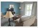 Inviting living room featuring sliding glass doors to balcony, neutral color palette, and TV at 5541 Bay Blvd # 310, Port Richey, FL 34668