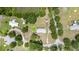 Aerial view of the property showcasing multiple buildings, surrounding trees, and pond access at 5613 Forest Creek Rd, Lakeland, FL 33810
