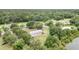 Tranquil homesite with trees, grass, and an above ground pool next to the house at 5613 Forest Creek Rd, Lakeland, FL 33810