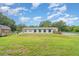 Home with a spacious lawn, storage shed, deck and above ground pool at 5613 Forest Creek Rd, Lakeland, FL 33810