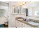 Well-lit bathroom featuring double sinks, granite countertops, and ample cabinet space at 5613 Forest Creek Rd, Lakeland, FL 33810