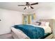 Neutral bedroom with large windows, ceiling fan, and plush bedding at 5613 Forest Creek Rd, Lakeland, FL 33810