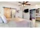 This bedroom has a large bed, barn door to bath, and a walk-in closet at 5613 Forest Creek Rd, Lakeland, FL 33810