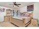 Bright bedroom featuring a decorative bed frame, dressers, and floral artwork at 5613 Forest Creek Rd, Lakeland, FL 33810