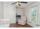 Comfortable bedroom with crib, neutral walls, ceiling fan and natural light at 5613 Forest Creek Rd, Lakeland, FL 33810