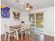 Dining room with seating for six, a sliding glass door to a sunroom, and colorful artwork at 5613 Forest Creek Rd, Lakeland, FL 33810