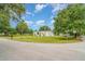 Quaint home on a spacious corner lot with mature trees, a well-maintained lawn, and a mailbox at 5613 Forest Creek Rd, Lakeland, FL 33810