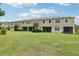 Large, well-maintained backyard showcasing multiple townhome units and green space at 5808 Grand Sonata Ave, Lutz, FL 33558