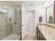 Modern bathroom featuring a glass-enclosed shower, vanity with granite countertop, and tile flooring at 5808 Grand Sonata Ave, Lutz, FL 33558