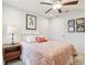 Bright bedroom featuring a ceiling fan, neutral walls and a charming quilt-covered bed at 5808 Grand Sonata Ave, Lutz, FL 33558