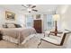 Bright bedroom with a patterned bedspread, ceiling fan, and natural light at 5808 Grand Sonata Ave, Lutz, FL 33558
