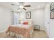 A bedroom with a floral bedspread, ceiling fan, and carpeted flooring at 5808 Grand Sonata Ave, Lutz, FL 33558