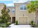 Charming two-story home with a well-maintained lawn, a beautiful tree, and an attached garage at 5808 Grand Sonata Ave, Lutz, FL 33558