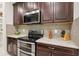 Close-up of a modern kitchen showcasing stainless steel appliances, and stylish cabinetry at 5808 Grand Sonata Ave, Lutz, FL 33558