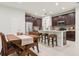 Stylish kitchen with dark wood cabinets, stainless steel appliances, and an island with seating at 5808 Grand Sonata Ave, Lutz, FL 33558