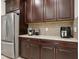 A kitchen with dark wood cabinets, granite countertops, and stainless steel appliances at 5808 Grand Sonata Ave, Lutz, FL 33558