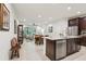 Open layout displaying kitchen island, stainless steel appliances, and seamless transition to living space at 5808 Grand Sonata Ave, Lutz, FL 33558