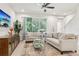 Bright living room featuring modern furniture, neutral color palette, and a view of the outdoors at 5808 Grand Sonata Ave, Lutz, FL 33558