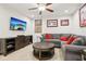 Cozy living room area showcasing a large sectional sofa, TV, and entertainment center at 5808 Grand Sonata Ave, Lutz, FL 33558