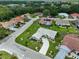 This aerial view captures a neighborhood with well-maintained lawns, mature trees, and diverse architectural styles at 602 Deep Lake Ln, Sun City Center, FL 33573