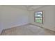 Bedroom with neutral carpet and a view of the front yard at 602 Deep Lake Ln, Sun City Center, FL 33573