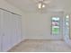 Bedroom with neutral carpet and a closet with bi-fold doors at 602 Deep Lake Ln, Sun City Center, FL 33573