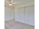 Bedroom with neutral carpet and a closet with bi-fold doors at 602 Deep Lake Ln, Sun City Center, FL 33573
