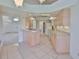 Bright kitchen features tile floors, light wood cabinets, and modern appliances at 602 Deep Lake Ln, Sun City Center, FL 33573