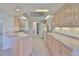 Bright kitchen features tile floors, light wood cabinets, and modern appliances at 602 Deep Lake Ln, Sun City Center, FL 33573