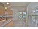 Cozy breakfast nook in a bright kitchen featuring tile floors, light wood cabinets, and a view to the backyard at 602 Deep Lake Ln, Sun City Center, FL 33573
