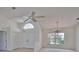 A bright and airy living room with high ceilings, a ceiling fan, tile floors and large windows offering natural light at 602 Deep Lake Ln, Sun City Center, FL 33573