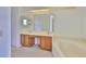 Main bathroom featuring double sinks, soaking tub, and large mirror at 602 Deep Lake Ln, Sun City Center, FL 33573