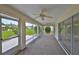 The covered screened-in lanai overlooks the lush lawn and landscaping at 602 Deep Lake Ln, Sun City Center, FL 33573