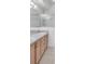 Well-lit bathroom features dual sinks, light wood cabinets, and a framed shower with glass doors at 6044 Sandhill Ridge Dr, Lithia, FL 33547