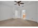 Bedroom boasts tray ceilings, a ceiling fan, and doorway access to an en-suite bathroom at 6044 Sandhill Ridge Dr, Lithia, FL 33547