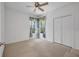 Bedroom showcases a large window with floral curtains and a double door closet for storage at 6044 Sandhill Ridge Dr, Lithia, FL 33547