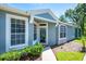 Inviting home entry with stylish windows, a well-maintained walkway, and attractive landscaping at 6044 Sandhill Ridge Dr, Lithia, FL 33547